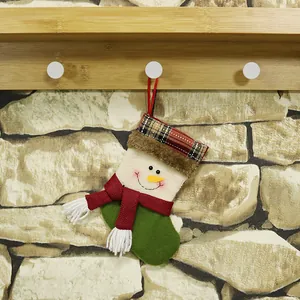 Classic snowman Christmas stocking with plaid trim and red tassel for holiday gift bags