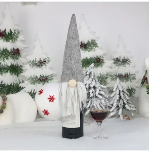 Macro view of Christmas gnome wine bottle cover with grey felt hat and white beard detail
