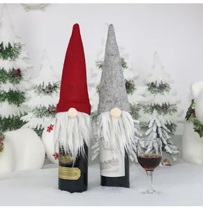 Close-up of gnome wine bottle covers with felt hats and white plush beards for Christmas