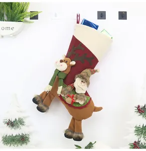 Detail of Christmas stocking with 3D reindeer decor and small Santa Claus hanging pendant