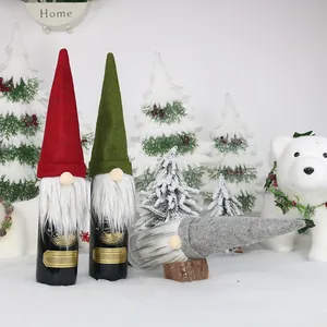 Three Christmas gnome wine bottle covers in red, green and grey for festive table decor