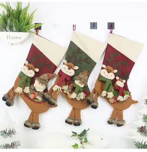 Detailed view of three hanging Christmas stockings with 3D reindeer, snowman and Santa