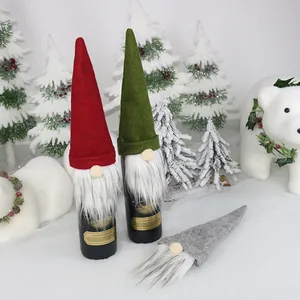Three Christmas gnome wine bottle covers in red green and grey for holiday table decor