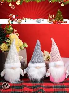 Close-up of three festive Christmas gnomes with sequined hats and plush faux fur beards