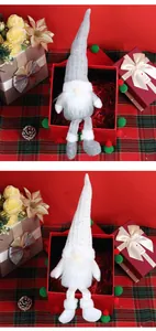 Detail view of plush long-legged Christmas gnomes with sequined hats in gift packaging
