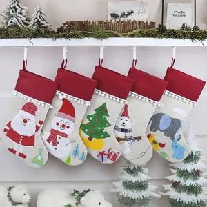 Set of 5 Christmas stockings with embroidered Santa and snowman hanging on a fireplace