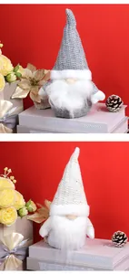 Close-up of knit Christmas gnomes with silver sequins and long plush beards