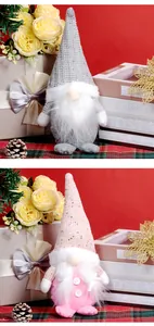 Detailed view of grey and pink faceless Christmas gnomes with knit hats on festive red background