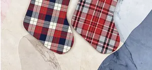 Macro shot of classic plaid Christmas stockings in red blue and monochrome tartan patterns