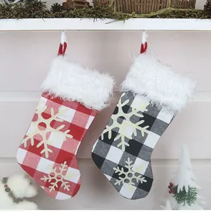 Detail of red and black buffalo plaid Christmas stockings with fluffy faux fur and snowflakes