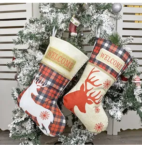 Macro view of Christmas stockings with moose prints and plaid patterns on a tree