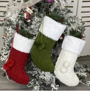 Close-up of knit Christmas stockings in red, green, and white with plush faux fur trim