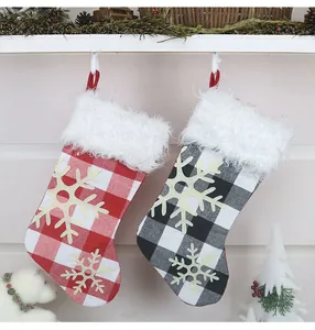 Detail of buffalo plaid Christmas stockings with snowflake appliques and faux fur trim