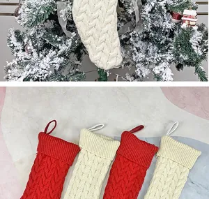 Detail of cable knit Christmas stockings in red and cream white with hanging loops