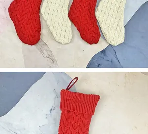 Detail of cable knit pattern on thick red and cream Christmas stockings with hanging loops