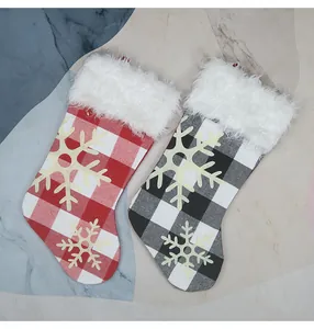Close-up of buffalo plaid Christmas stockings with white faux fur and snowflake applique