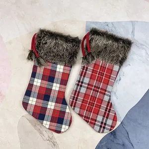 Classic plaid Christmas stockings with brown faux fur trim and pom-poms for holiday decor