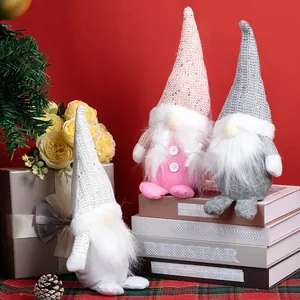 Three Nordic Christmas gnomes with sequin hats and long white beards in a festive setting