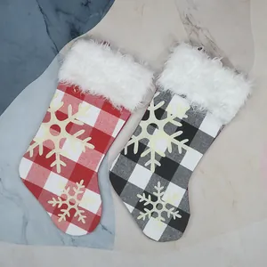 Set of two Christmas stockings in red and black buffalo plaid with plush cuffs and snowflakes