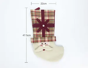 Detail view of 47.5cm Christmas stocking with plaid pattern and Santa Claus design