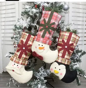 Three-piece set of hanging Christmas stockings with Santa, snowman and penguin details