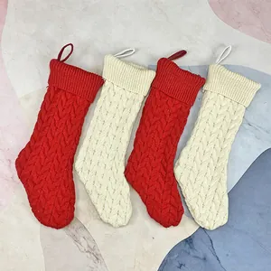 Set of 4 large cable knit Christmas stockings in red and white for holiday home decoration
