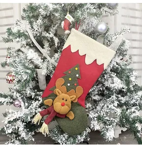 Detail of Christmas stocking featuring 3D reindeer and felt tree on festive tree branch