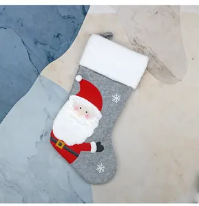 Detail view of grey felt Christmas stocking with plush faux fur trim and Santa appliqué