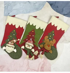 Detailed view of three 3D Christmas stockings featuring Santa, Snowman and Reindeer