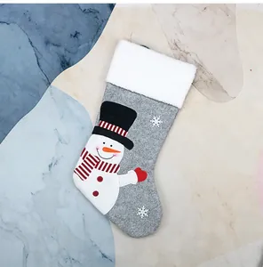 Detail of grey felt Christmas stocking with 3D snowman and white faux fur trim ornament