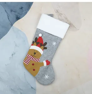 Detail of Christmas stocking featuring 3D cartoon reindeer embroidery and faux fur trim