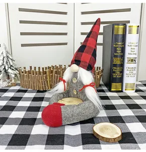 Macro detail of Christmas gnome buckle with buffalo plaid hat and wood slice tray