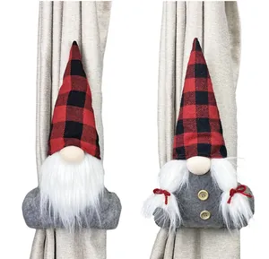 Close-up of Christmas gnome curtain tiebacks with red plaid hats on a beige curtain