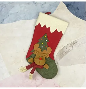 Detailed view of Christmas stocking with 3D reindeer and tree embroidery on marble background