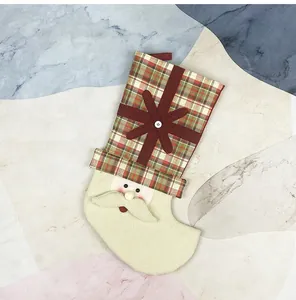 Detail of Santa Claus Christmas stocking with plaid fabric and soft sherpa wool accents