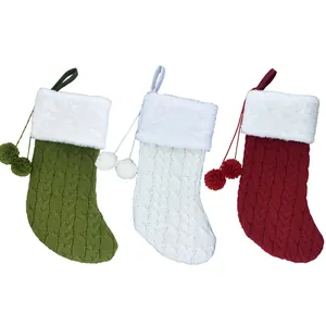 Three knit Christmas stockings in red, green, and white with plush faux fur cuffs and pom-poms