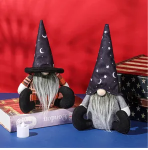 Detail of two Halloween gnome plushies with wizard hats and stars on a vibrant background