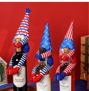 Three USA Independence Day gnomes decorating wine bottles with red and blue star patterns