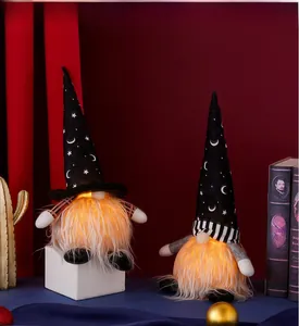 Close-up of glowing Halloween gnomes with LED lights and moon star pattern hats