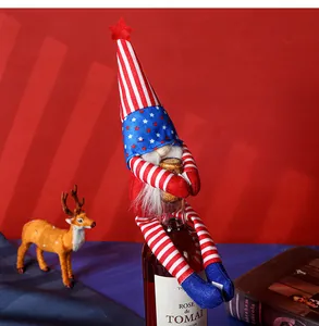 Detail of USA flag themed gnome wine bottle cover with red stars and long striped hat