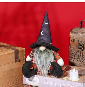 Macro detail of Halloween faceless gnome with starry hat and plaid clothes on red backdrop
