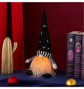 Detail of a Halloween glowing gnome with moon pattern hat and orange lighted beard