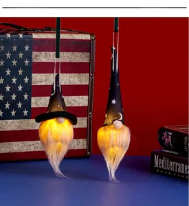 Close-up of glowing Halloween gnomes with illuminated beards and star pattern wizard hats