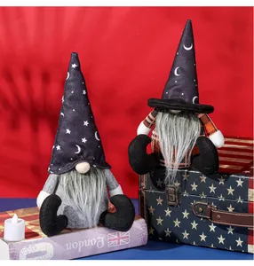 Detail of two Halloween gnomes with star and moon hats sitting on vintage boxes