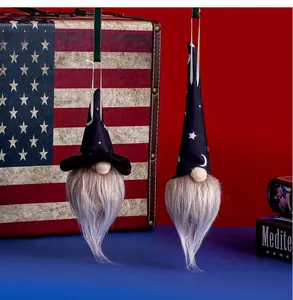 Detail of hanging Halloween gnomes with star and moon patterns and glowing beards