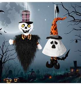 Detail of plush Halloween hanging ornaments with skeleton and ghost in a spooky graveyard