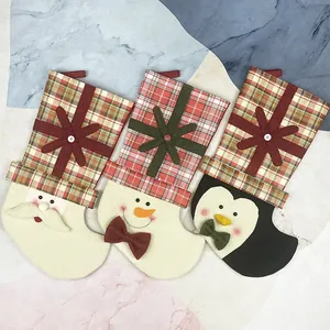 Three-piece Christmas stocking set featuring Santa, snowman, and penguin designs with plaid trim
