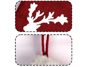 Detail of red Christmas stocking with white reindeer patch and faux fur trim