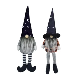 Pair of Halloween gnomes with star and moon wizard hats and striped long legs
