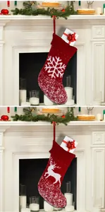 Close-up of red knitted Christmas stockings with reindeer and snowflake patterns